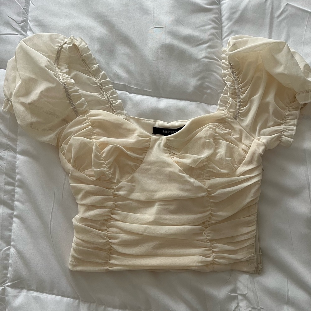 Mesh touched cream top